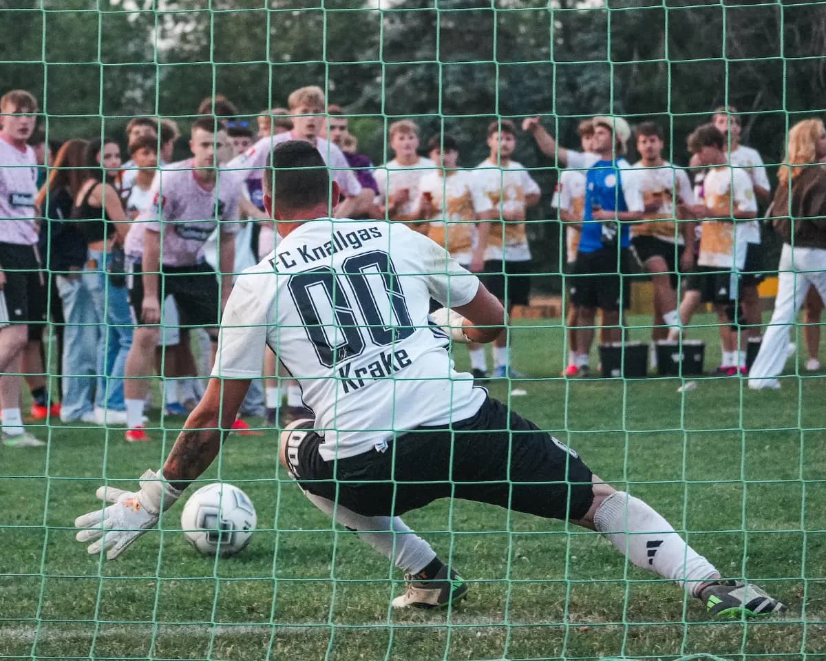 Der Torwart von FC Knallgas hechtet, der Ball liegt links neben ihm
