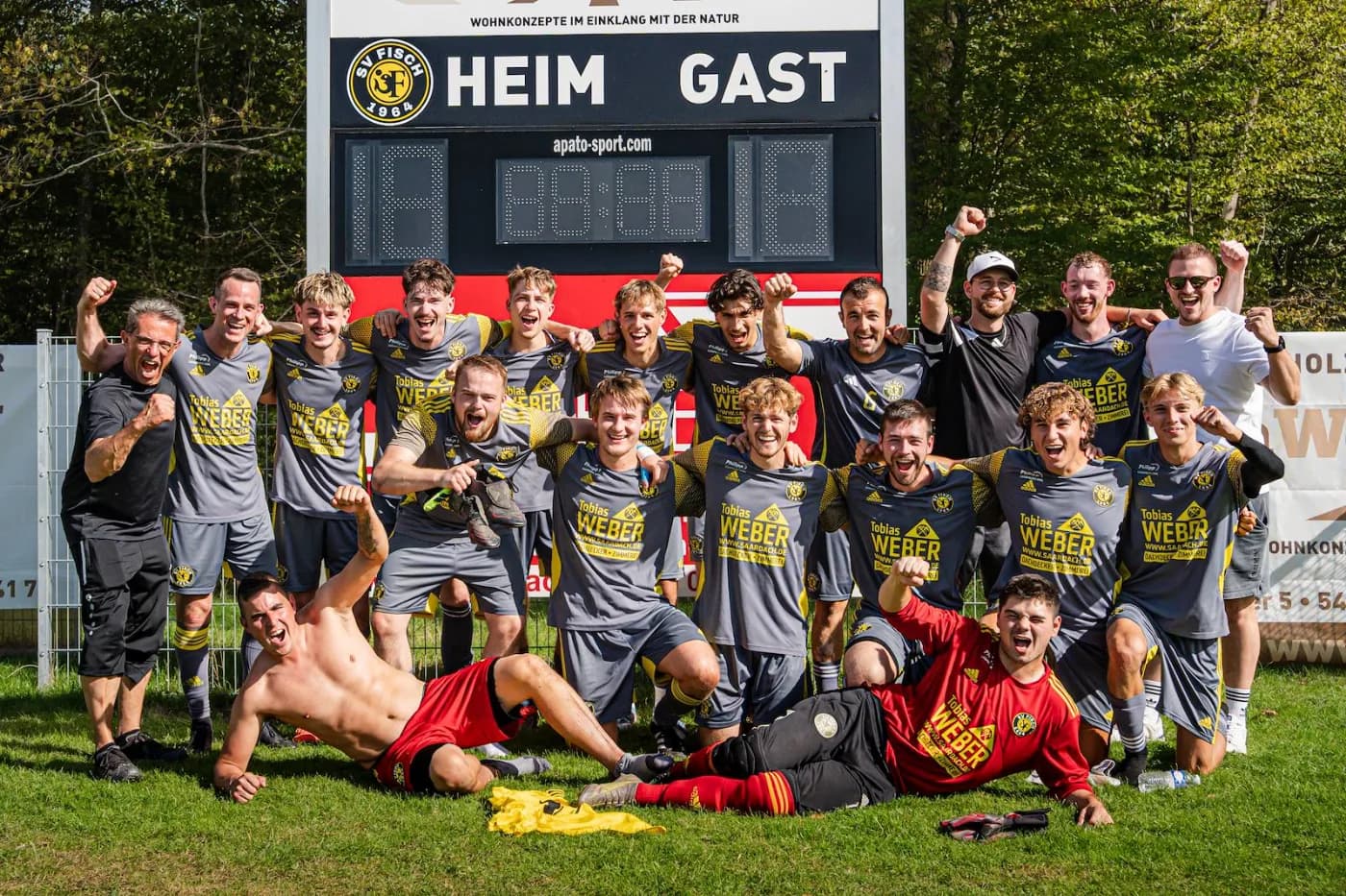 Die Mannschaft feiert nach dem Spiel vor der Anzeigetafel, einige liegen im Gras